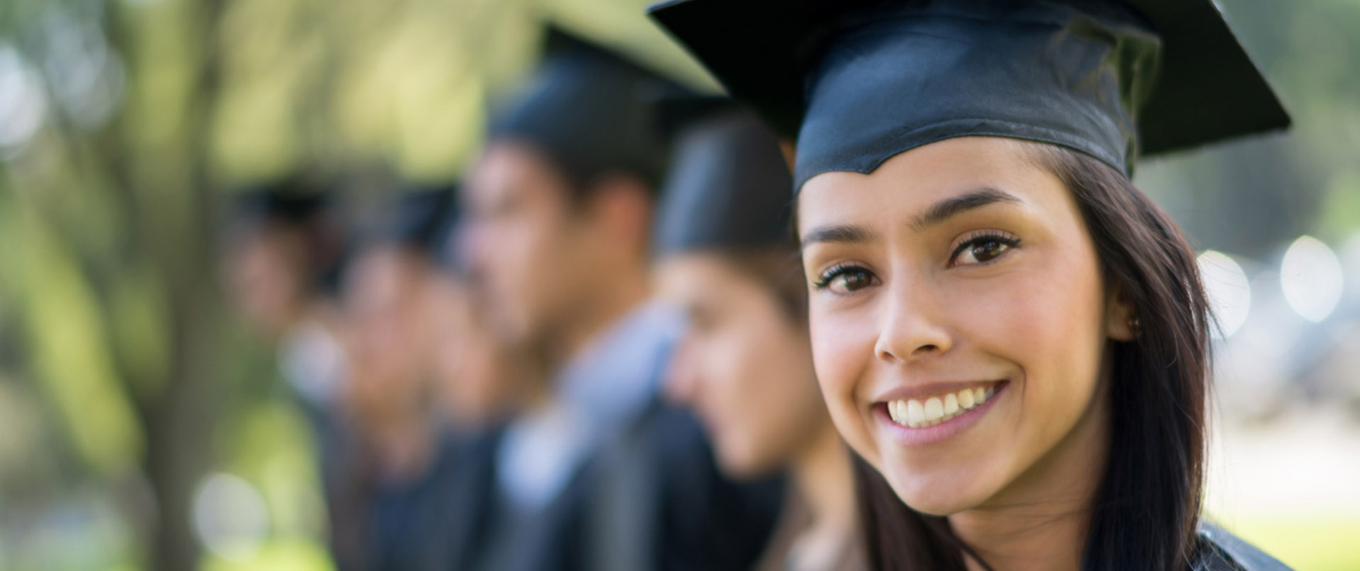 graduate wearing cap and gown