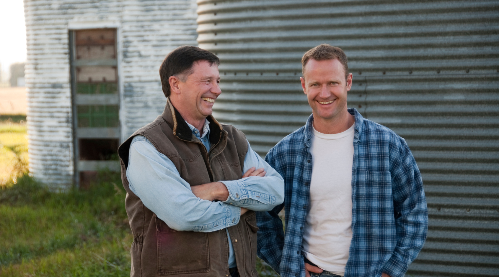 two farmers by grain bin